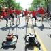 Members of the Redford Jaycees junior chamber perform a "Rockette" inspired kick line as they march with lawnmowers in the 22nd Annual Fourth of July Parade hosted by the Ann Arbor Jaycees in downtown Ann Arbor. Melanie Maxwell I AnnArbor.com